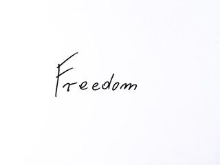 Minimal handwritten &ldquo;freedom&rdquo; on white background. Concept symbolizing independence, liberation and free expression.