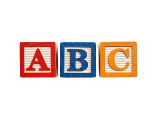 Colorful wooden toy blocks spelling "ABC" against a stark black background