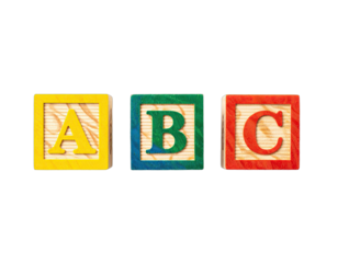 Bright, primary-colored wooden blocks with ABC letters on display against a black background
