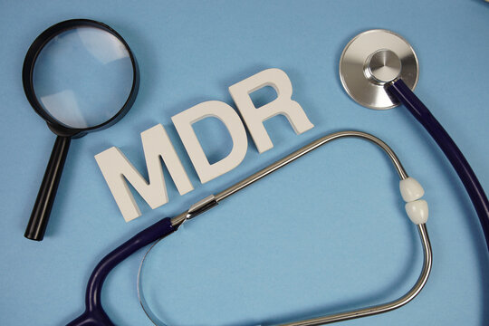 MDR abbreviation of Merchant Discount Rate alphabet letters with magnifying glass and stethoscope on blue background