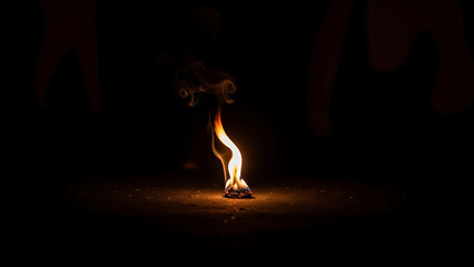 Close up view of burning paper on dark ground with smoke in dim light mysterious atmosphere
