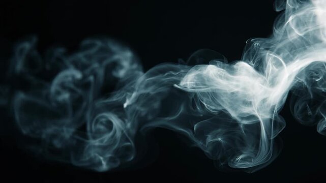 Mysterious white smoke flowing in slow motion swirl across dark background, this ethereal vapor creating calm abstract texture with beautiful and wispy pattern