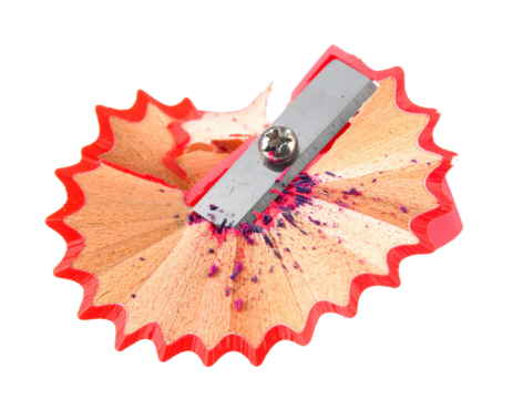 Close-up of a red pencil sharpener with colorful shavings. - Powered by Adobe