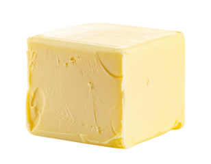A single cube of butter on a white background.