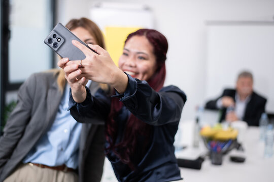 Colleagues Taking a Selfie Together in a Professional Office Setting - Powered by Adobe