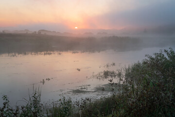 The valley of the Sorot River near the Mikhailovskoye Estate of the Pushkin Museum-Reserve at dawn on a foggy summer morning, Pushkinskiye Gory, Pskov Oblast, Russia