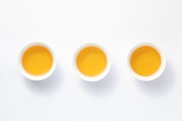 Three cups of tea are placed on a white background.