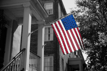 Charleston: Colorful American flag on historic porch.