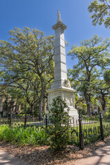 Pulaski Monument, Savannah, Georgia, amidst sunlit oak trees.
