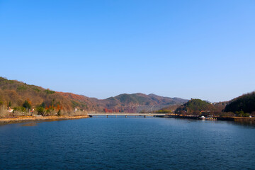 Fototapeta premium A wide deep river and a long mountain