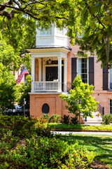 Charleston, SC: Historic pink house, American flag, and live oaks.