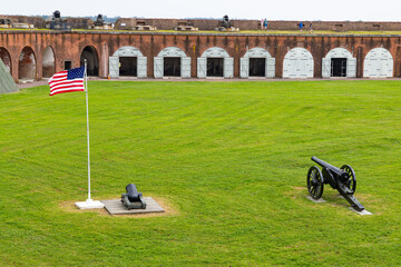 Fort Pulaski: Historic brick fort, American flag, cannons, green field.