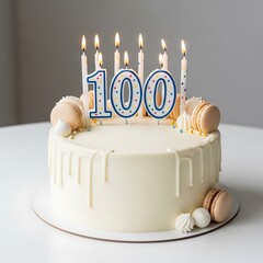 One hundredth birthday cake with lit candles and white chocolate drip