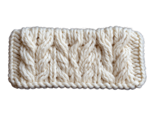 A close-up view of a knitted yarn blanket with a cable pattern on a white background