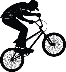 Obraz premium Action Silhouette of a Young Male Biker Performing a Wheelie Stunt on a BMX Bike for Extreme Sports and Urban Lifestyle