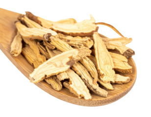 Dried Astragalus Root Slices on Wooden Spoon.