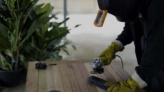 Grinder Prepares For Iron Work, A professional documentary clip of grinder gearing up for forging, steel dust swirling in focused beams, ideal for industrial skill film or precision tool documentary.