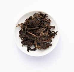Tea sample in white dish. Black tea sample. Tea leaves on white background.	black tea leaves on a white background