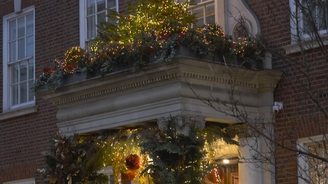 Christmas Tree Lights, Brick Building Illuminated Festive Holiday Decorations Glow At Night, Mayfair, Central London, United Kingdom