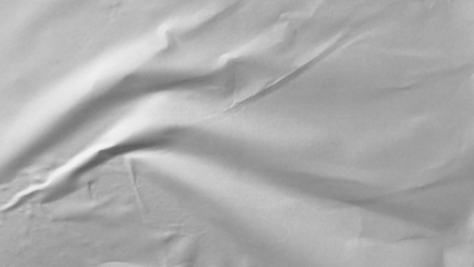 Glued paper texture. Crumpled and wrinkled surface of plain black paper poster background. Wrinkled wet paper