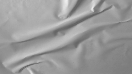 Glued paper texture. Crumpled and wrinkled surface of plain black paper poster background. Wrinkled wet paper