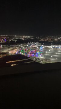 Night timelapse of cityscape with mall, cars, and amusement park lights &mdash; urban skyline and traffic motion captured in vibrant city night scene