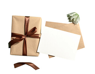 Wrapped gift, blank card, envelope and flower