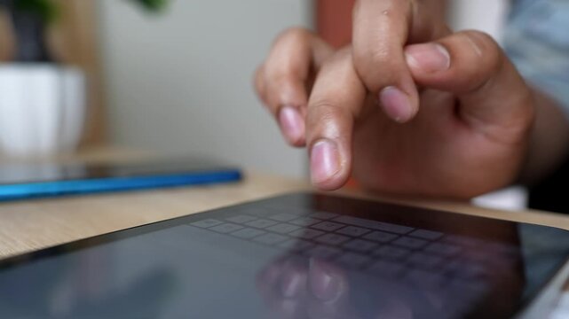 Close-up of Tablet Use with Smartphone Nearby