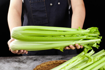 Fresh Green Celery Bunch in Hands - Healthy Diet Still Life