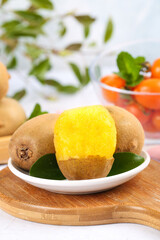 Fresh Golden Kiwifruit Still Life with Green Leaves