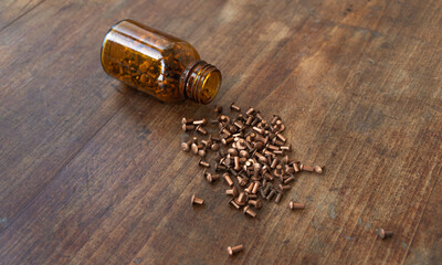A jar with copper rivets on the table.