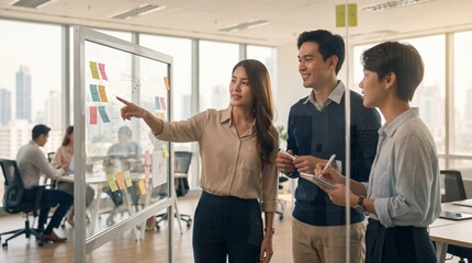 Three diverse business professionals are collaborating on a project in an office.
