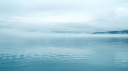Fototapeta premium Mysterious foggy lake serenity at dawn tranquil water landscape with ethereal mist.