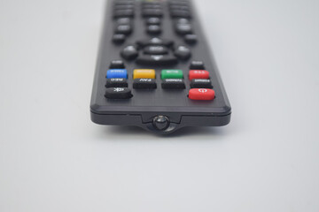 Front view of a black television remote control showing the infrared transmitter bulb and colorful buttons