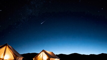Lit tents on a mountain clearing at nightfall, alongside a starry sky and meteor trails - Ideal for outdoor adventures and astrophotography sharing