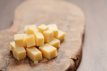 Pieces of hard vintage cheese on wood olive board