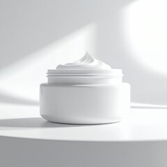 White cosmetic cream jar with soft shadows on a clean background.