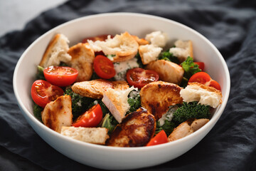 Caesar salad alternative with kale and turkey in white bowl