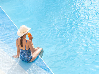Cute woman relaxing with a drink by the cruise ship pool on a sunny, clear morning. Top view. Vacation and travel concept. Chill lifestyle, luxury travel. Perfect for holiday and travel themes © Svetlana