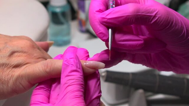 Detailed Salon Hand, Client Hand Receives Expert Shaping, Closeup Of White Hand With Pink Glove Working. Media