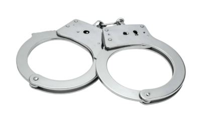 Close-up of silver, metallic, open handcuffs against a black background