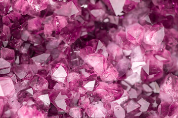 Amethyst pink crystals. Gems. Mineral crystals in the natural environment. Texture of precious and semiprecious stones. Seamless background with copy space colored shiny surface of precious stones.