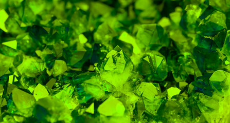 Green crystal mineral stone. Gems. Mineral crystals in the natural environment. Texture of precious and semiprecious stones. Seamless background with copy space colored shiny surface of precious stone © Vera