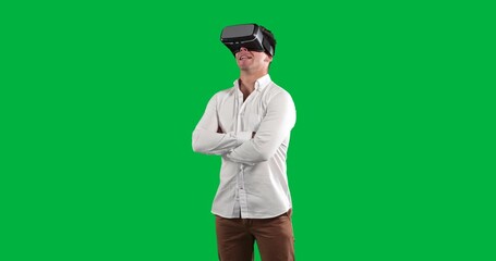 Man wearing VR headset standing against transparent backdrop, projecting technology icons, charts