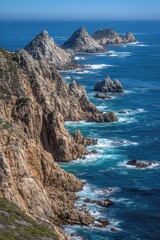 Rugged Cliffs Extending into Deep Blue Ocean Water Under Bright Sunny Day Light in California Coastline