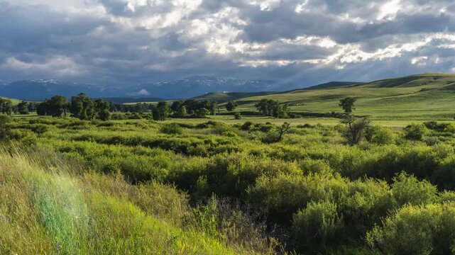 Moody clouds and mountains in distance timelapse 