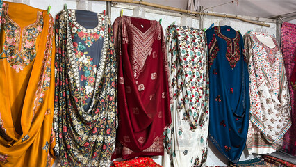 traditional indian kurtis hanging on clothing rack in local shop