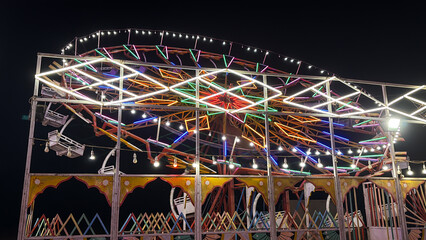 vibrant ferris wheel glowing with colorful lights at night traditional local fair