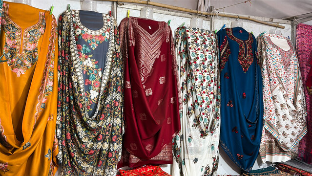 traditional indian kurtis hanging on clothing rack in local shop