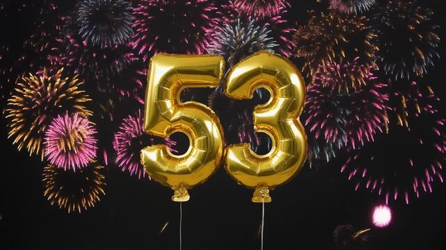 Gold balloon number 53 with fireworks in the background. Festive scene for birthday or anniversary party